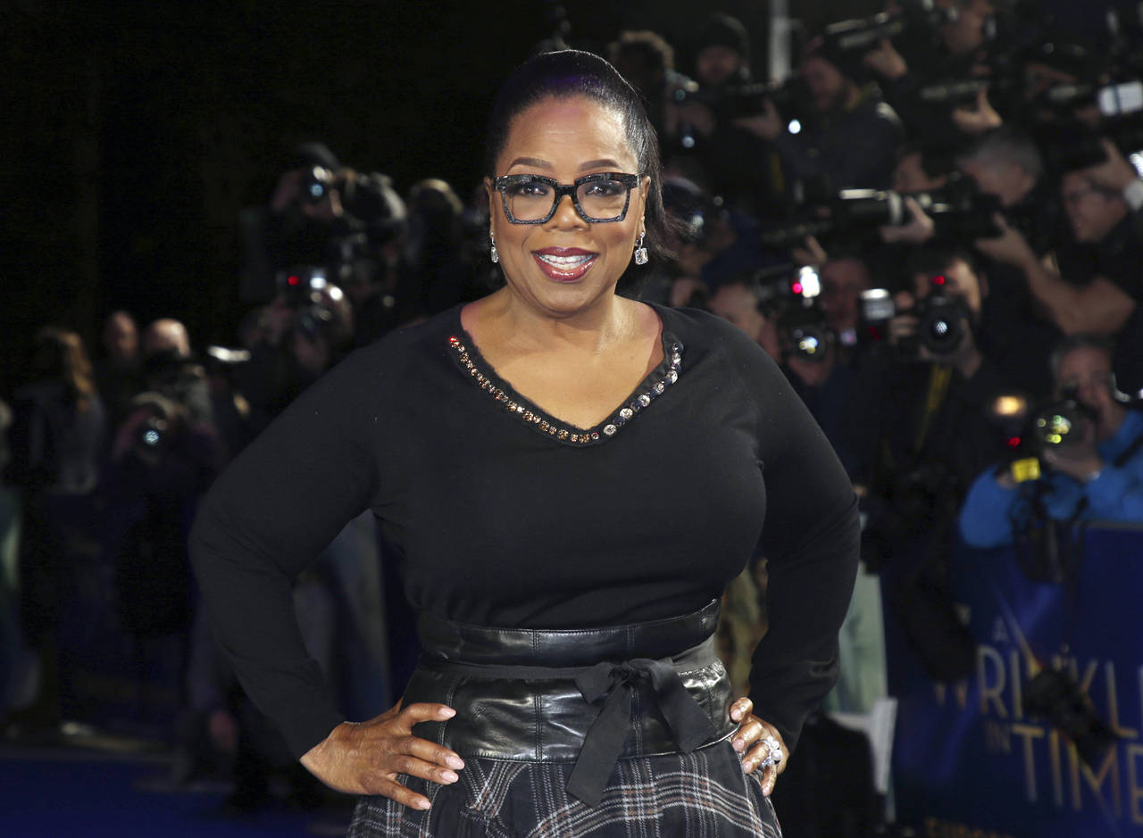 FILE - In this March 13, 2018, file photo, actress Oprah Winfrey poses for photographers upon arriv...