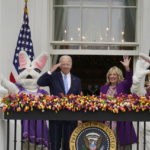 
              President Joe Biden appears and salutes with first lady Jill Biden and the Easter Bunnies on the Blue Room balcony at the White House during the White House Easter Egg Roll, Monday, April 18, 2022, in Washington. (AP Photo/Andrew Harnik)
            
