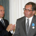 
              FILE - Russian President Vladimir Putin applauds then Alfa Bank head Petr Aven after awarding him with the Order of Merit to the Fatherland during a ceremony at the Kremlin in Moscow, July 25, 2005. The sanctions on Russian oligarchs have shaken up the world of Jewish philanthropy. Three oligarchs who have been sanctioned by the West -- Mikhail Fridman, Petr Aven and German Khan -- abruptly resigned in March 2022, from the Genesis Philanthropy Group that funds projects to strengthen Jewish communities and causes around the world. (AP Photo/Alexander Nenenov, Pool, File)
            