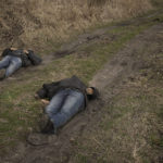 
              The lifeless bodies of two men lie on a dirt path in Bucha, Ukraine, Monday, April 4, 2022. Russia faced a fresh wave of condemnation on Monday after evidence emerged of what appeared to be deliberate killings of civilians in Ukraine. Some Western leaders called for further sanctions in response, even as Moscow continued to press its offensive in the country's east. (AP Photo/Vadim Ghirda)
            