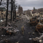 
              FILE - A Ukrainian serviceman walks amid destroyed Russian tanks in Bucha, on the outskirts of Kyiv, Ukraine, April 6, 2022. Russia is bracing up for a massive new offensive in eastern Ukraine, hoping to reverse its fortunes on the battlefield after a catastrophic start of the invasion. (AP Photo/Felipe Dana, File)
            