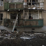 
              A woman stands on the balcony of her apartment, damaged after a Russian bombardment in Kharkiv, Ukraine, Thursday, April 21, 2022. (AP Photo/Felipe Dana)
            
