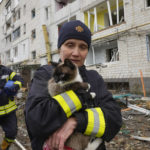 
              An emergency worker holds a rescued cat in Borodyanka, Ukraine, Wednesday, Apr. 6, 2022. Ukrainian authorities are poring over the grisly aftermath of alleged Russian atrocities around Kyiv, as both sides prepare for an all-out push by Moscow's forces to seize Ukraine’s industrial east. (AP Photo/Efrem Lukatsky)
            