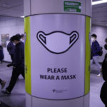 
              People wearing face masks pass by a poster reminding precautions against the coronavirus at a subway station in Seoul, South Korea, Friday, April 29, 2022. (AP Photo/Ahn Young-joon)
            