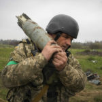 
              A Ukrainian soldier carries an unexploded Russian air bomb in the village of Kolonshchyna, Ukraine, Thursday, April 21, 2022. (AP Photo/Efrem Lukatsky)
            