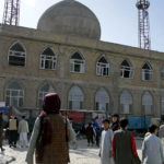 
              FILE - This frame grab image from video, shows a Taliban fighter standing guard outside the site of a bomb explosion inside a mosque, in Mazar-e-Sharif province, Afghanistan, Thursday, April 21, 2022. A deadly Islamic State affiliate on Friday, April 22, 2022, claimed a series of bombings  a day earlier that targeted Afghanistan’s minority Shiite Muslims, while Pakistan issued a warning of IS threats in its eastern Punjab province. (AP Photo, File)
            