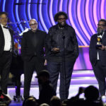 
              Robert Fyvolent, from left, David Dinerstein, Questlove, and Joseph Patel accept the award for best music film album for "Summer Of Soul" at the 64th Annual Grammy Awards on Sunday, April 3, 2022, in Las Vegas. (AP Photo/Chris Pizzello)
            