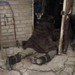 
              A dog stands next to the body of an elderly woman killed at the entrance of her house in Bucha, outskirts of Kyiv, Ukraine, Tuesday, April 5, 2022. (AP Photo/Felipe Dana)
            