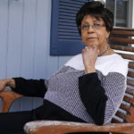 
              Roberta Wolff, a descendant of Tony, Cuba and Darby Vassall who were enslaved by Harvard benefactors in the institution's first decades, poses on the front porch of her family home, Wednesday, April 27, 2022, in Bellingham, Mass. In Harvard's pledge to atone for its ties to slavery, it identified dozens of people who were enslaved by the university's first leaders and faculty members. Hundreds of years later, their living descendants are estimated to number in the thousands, including some who lived and worked in the Boston area without knowing their family connection to the Ivy League school. (AP Photo/Charles Krupa)
            