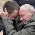 
              Relatives cry at the mass grave of civilians killed during Russian occupation in Bucha, on the outskirts of Kyiv, Ukraine, Friday, April 8, 2022. An international organization formed to identify the dead and missing from the 1990s Balkan conflicts is preparing to send a team of forensics experts to Ukraine as the death toll mounts more than six weeks into the war caused by Russia's invasion. (AP Photo/Efrem Lukatsky)
            