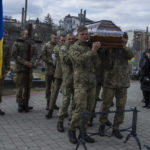 
              Soldiers carry the coffin of 41-year-old soldier Simakov Oleksandr, during his funeral ceremony, after he was killed in action, at the Lychakiv cemetery, in Lviv, western Ukraine, Monday, April 4, 2022. (AP Photo/Nariman El-Mofty)
            