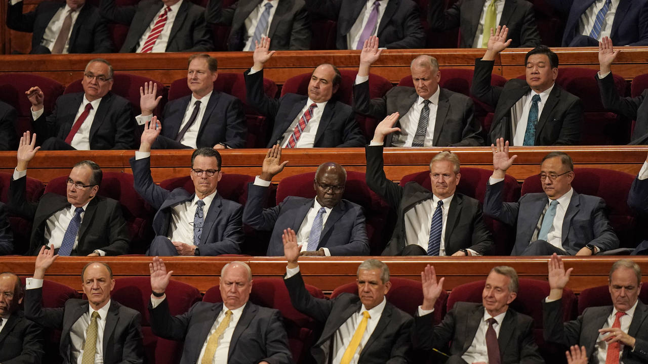 Church leaders raise their hands during a sustaining vote during The Church of Jesus Christ of Latt...