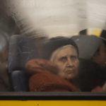 
              An internally displaced elderly woman from Mariupol looks out of a bus after window arriving at a refugee center fleeing from the Russian attacks, in Zaporizhzhia, Ukraine, Thursday, April 21, 2022. Mariupol, which is part of the industrial region in eastern Ukraine known as the Donbas, has been a key Russian objective since the Feb. 24 invasion began. (AP Photo/Leo Correa)
            