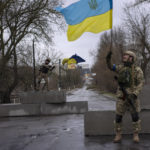 
              Ukrainian soldiers celebrate at a check point in Bucha, in the outskirts of Kyiv, Ukraine, Sunday, April 3, 2022. (AP Photo/Rodrigo Abd)
            