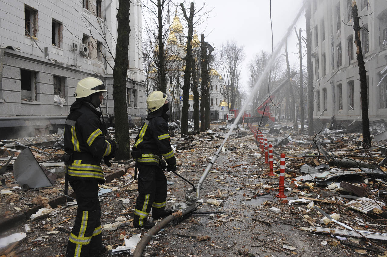 FILE - Firefighters extinguish a building of Ukrainian Security Service (SBU) after a rocket attack...