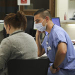 
              In this image provided by the U.S. Army, U.S. Air Force 2nd Lt. Benjamin Eells, a nurse assigned to a military medical team, works with Kailey Hollenbeck, a hospital registered nurse, while supporting the COVID-19 response operations at University of Rochester Medical Center, in Rochester, N.Y., March 5, 2022. (Spc. Khalan Moore/U.S. Army via AP)
            
