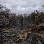 
              A man carries bicycle along a street filled with destroyed Russian military vehicles near Chernihiv, Ukraine, Sunday, April 17, 2022. Witnesses said multiple explosions believed to be caused by missiles struck the western Ukrainian city of Lviv early Monday as the country was bracing for an all-out Russian assault in the east. (AP Photo/Evgeniy Maloletka)
            