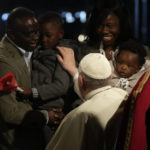 
              Pope Francis greets faithful as he presides over the Via Crucis (Way of the Cross) torchlight procession on Good Friday in front of Rome's Colosseum, in Rome, Friday, April 15, 2022. (AP Photo/Gregorio Borgia)
            