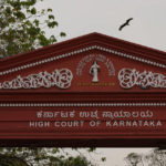 
              A bird flies over the main entrance of High Court of Karnataka, in Bengaluru, India, Monday, March 21, 2022. An Indian court ruling upholding a ban on Muslim students wearing head coverings in schools has sparked criticism from constitutional scholars and rights advocates amid concerns of judicial overreach regarding religious freedoms. (AP Photo/Aijaz Rahi)
            