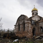 
              Russian army vehicles are burned outside a damaged church, in Lukashivka, near the city of Chernihiv in northern Ukraine, on Friday, April 22, 2022. A single metal cross remains inside the Orthodox church of shattered brick and blackened stone. Residents say Russian soldiers used the house of worship for storing ammunition, and Ukrainian forces shelled the building to make the Russians leave. (AP Photo/Petros Giannakouris)
            