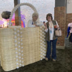
              A performer and fan both dressed as the character of Sophia from TV's "The Golden Girls" pose with a giant replica of Sophia's trademark purse at a fan convention in Chicago, Friday, April 22, 2022. Golden-Con, which lasts thru Sunday, is giving those who adored the NBC sitcom a chance to mingle, see panels and buy merchandise. The show, which ran from 1985-1992, starred Bea Arthur, Rue McClanahan, Estelle Getty and Betty White—who died at age 99 in December. (AP Photo/Terry Tang)
            