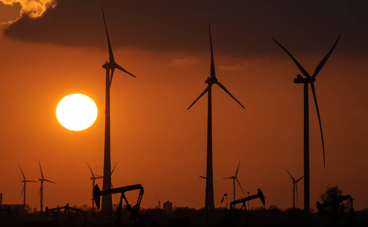 FILE -Wind turbines produce power during sundown in Emlichheim, Germany, Friday, March 18, 2022. Th...