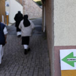 
              Nuns of the Baumgarten abbey walk to cast her vote in the first round of the French presidential election, in Bernardville, eastern France Sunday, April 10, 2022. The polls opened at 8am in France for the first round of its presidential election where up to 48 million eligible French voters will be choosing between 12 candidates. (AP Photo/Jean-Francois Badias)
            