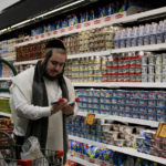 
              Moshe Werzberger shops for Passover food and other groceries at a kosher supermarket in the Hasidic Jewish section of Brooklyn’s Williamsburg neighborhood in New York on April 19, 2022. Some U.S. Jewish families observing the Passover are struggling to pay for matzo, eggs and gefilte fish and worry about how soaring inflation is driving up prices during one of the most important holidays for Jews. (AP Photo/Luis Andres Henao)
            