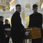 
              Men carry coffins during a funeral ceremony for Kira Glodan, three-month-old, her mother Valerya Glodan, 28, and grandmother Lyudmila Yavkina, 54, killed in their apartment by shelling, at the Transfiguration Cathedral in Odessa, Ukraine, Wednesday, April 27, 2022. According Ukrainian officials five people including a three-month-old infant were killed and 18 injured in a missile attack in the Black Sea port city of Odesa on last Saturday, April 23. (AP Photo/Max Pshybyshevsky)
            