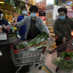 
              Residents wearing masks shop at a supermarket in the Chaoyang district of Beijing, Monday, April 25, 2022. Mass testing started Monday in Chaoyang district, home to more than 3 million people in the Chinese capital, following a fresh COVID-19 outbreak. (AP Photo/Ng Han Guan)
            