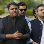 
              Leaders of the Pakistan Tehreek-e-Insaf opposition party Fawad Chaudary, center left, and Hamad Azhar, right, talk to media outside the National Assembly, in Islamabad, Pakistan, Monday, April 11, 2022. Pakistan's parliament elected opposition lawmaker Sharif as the new prime minister Monday, following a week of political turmoil that led to the weekend ouster of Premier Imran Khan. (AP Photo/Anjum Naveed)
            