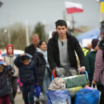 
              People return back to Ukraine at the border crossing in Medyka, southeastern Poland, Saturday, April 9, 2022. (AP Photo/Sergei Grits)
            