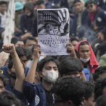 
              A student holds a poster with portraits of President Joko Widodo during a rally in Jakarta, Indonesia, Thursday, April 21. 2022. Hundreds of protesters, mostly students, took to the streets Thursday in Indonesia's capital, demanding the government stop attempts to postpone the 2024 presidential election, which would allow President Joko Widodo to remain in office beyond the two-term legal limit, calling it a threat to the country's democracy. (AP Photo/Tatan Syuflana)
            