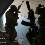 
              Security Service of Ukraine (SBU) servicemen enter a building during an operation to arrest suspected Russian collaborators in Kharkiv, Ukraine, Thursday, April 14, 2022. (AP Photo/Felipe Dana)
            