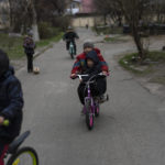 
              Children play in Bucha, in the outskirts of Kyiv, Ukraine, Wednesday, April 13, 2022. (AP Photo/Rodrigo Abd)
            