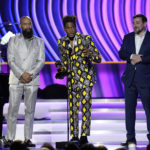 
              Alan Ferguson, from left, Jon Batiste and Alex P. Willson accept the award for best music video for "Freedom" at the 64th Annual Grammy Awards on Sunday, April 3, 2022, in Las Vegas. (AP Photo/Chris Pizzello)
            