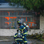 
              Firefighters work on a five-alarm fire at the Home Depot off Blossom Hill Road in San Jose, Calif., on Saturday, April 9, 2022. A shelter-in-place advisory was expected to remain in effect until at least early Sunday afternoon for residents living or working near the store that was destroyed Saturday in a fiery blaze. (Shae Hammond/Bay Area News Group via AP)
            