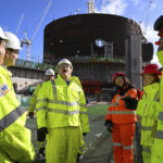 
              Britain's Prime Minister Boris Johnson meets apprentices during a visit to Hinkley Point C nuclear power station construction site in Somerset, England, Thursday, April 7, 2022. Britain plans to build eight new nuclear reactors and expand production of wind energy as it seeks to reduce dependence on oil and natural gas from Russia and other foreign suppliers following the invasion of Ukraine. (Finnbarr Webster/Pool Photo via AP)
            