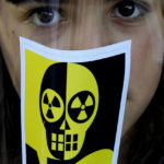 
              A girl with an anti-nuclear sticker on a mask is seen during a demonstration as Greek Cypriot and Turkish Cypriot activists voice their unease over the ongoing construction of the Russian-owned Akkuyu nuclear power plant in southern Turkey, some 60 miles (100 km) from the island nation's northern coastline, inside the United Nations controlled buffer zone that cuts across the capital Nicosia, Cyprus, on Wednesday, April 27, 2022. Activists say uncertainty over the safety of war-wracked Ukraine's nuclear power plants has re-ignited concerns over a Russian-owned nuclear power plant that's currently being built in a quake-prone area on Turkey's southern coastline. (AP Photo/Petros Karadjias)
            