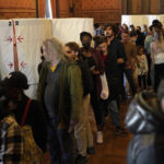 
              People queue to vote for the first round of the presidential election at a polling station Sunday, April 10, 2022 in Marseille, southern France. French voters headed to polling stations nationwide Sunday for the first round of the country's presidential election, one that seemed for months like a shoo-in for French President Emmanuel Macron but is now a tossup amid a strong challenge from the far right's Marine Le Pen. (AP Photo/Daniel Cole)
            