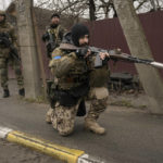 
              A Ukrainian serviceman secures the retreat of fellow soldiers who checked bodies lying on the street for booby traps in the formerly Russian-occupied Kyiv suburb of Bucha, Ukraine, Saturday, April 2, 2022. As Russian forces pull back from Ukraine's capital region, retreating troops are creating a "catastrophic" situation for civilians by leaving mines around homes, abandoned equipment and "even the bodies of those killed," President Volodymyr Zelenskyy warned Saturday.(AP Photo/Vadim Ghirda)
            