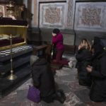 
              The wife, center, of 44-year-old soldier Tereshko Volodymyr, second right,  prays and mourns his death before his funeral ceremony, after he was killed in action, at the Holy Apostles Peter and Paul Church in Lviv, western Ukraine, Monday, April 4, 2022. (AP Photo/Nariman El-Mofty)
            