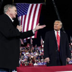 
              FILE - Former Sen. David Perdue of Georgia, speaks as President Donald Trump looks on, at a campaign rally at Valdosta Regional Airport, Dec. 5, 2020, in Valdosta, Ga. Perdue is building his campaign around Donald Trump and veering to the right as he tries to unseat Republican Gov. Brian Kemp in a May 24 GOP primary. (AP Photo/Evan Vucci, File)
            