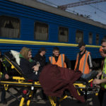 
              An elderly woman is carried on a stretcher before boarding a train at a train station in Pokrovsk, Ukraine, Monday, April 25, 2022, to flee the war in Severodonetsk and nearby towns. Russia unleashed a string of attacks against Ukrainian rail and fuel installations Monday, striking crucial infrastructure far from the front line of its eastern offensive. (AP Photo/Leo Correa)
            