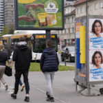 
              Pedestrians walk past electoral posters in Ljubljana, Slovenia, Thursday, April 21, 2022. The vote on Sunday April 24 in Slovenia will be held amid heightened political divisions in the small Alpine nation of 2 million. (AP Photo/Darko Bandic)
            