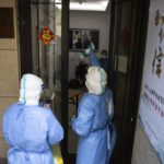 
              In this photo released by China's Xinhua News Agency, medical personnel spray disinfectant after taking samples for COVID-19 tests at a building in Shanghai, China, Saturday, April 16, 2022. Anti-virus controls that have shut down some of China's biggest cities and fueled public irritation are spreading as infections rise, hurting a weak economy and prompting warnings of possible global shockwaves. (Jin Liwang/Xinhua via AP)
            