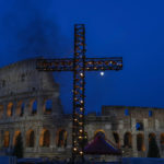 
              A cross lit with candles is seen in front of the Colosseum where Pope Francis will preside over the Via Crucis (Way of the Cross) torchlight procession on Good Friday in front of Rome's Colosseum, in Rome, Friday, April 15, 2022. (AP Photo/Gregorio Borgia)
            