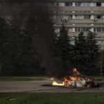 
              A car burns with two people inside, after a Russian bombardment in Kharkiv, Ukraine, Thursday, April 21, 2022. (AP Photo/Felipe Dana)
            
