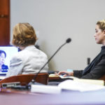 
              Actress Amber Heard, right, watches video testimony in the courtroom at the Fairfax County Circuit Courthouse in Fairfax, Va., Thursday, April 14, 2022.  Actor Johnny Depp sued his ex-wife Amber Heard for libel in Fairfax County Circuit Court after she wrote an op-ed piece in The Washington Post in 2018 referring to herself as a “public figure representing domestic abuse.” (Shawn Thew/Pool Photo via AP)
            