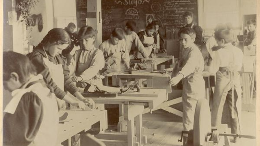 Students working in a sloyd room at the Indian Industrial School. (Photo courtesy of the William A....